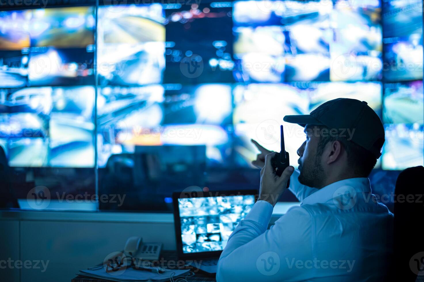 Security guards are monitoring multiple CCTV monitors.. photo