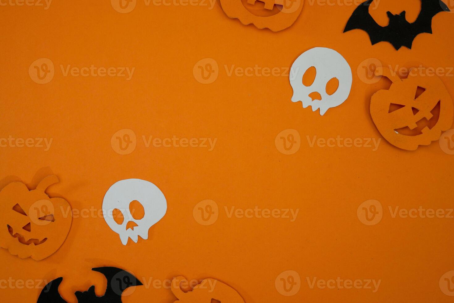 Pumpkin and skull paper cut out for copy space background photo