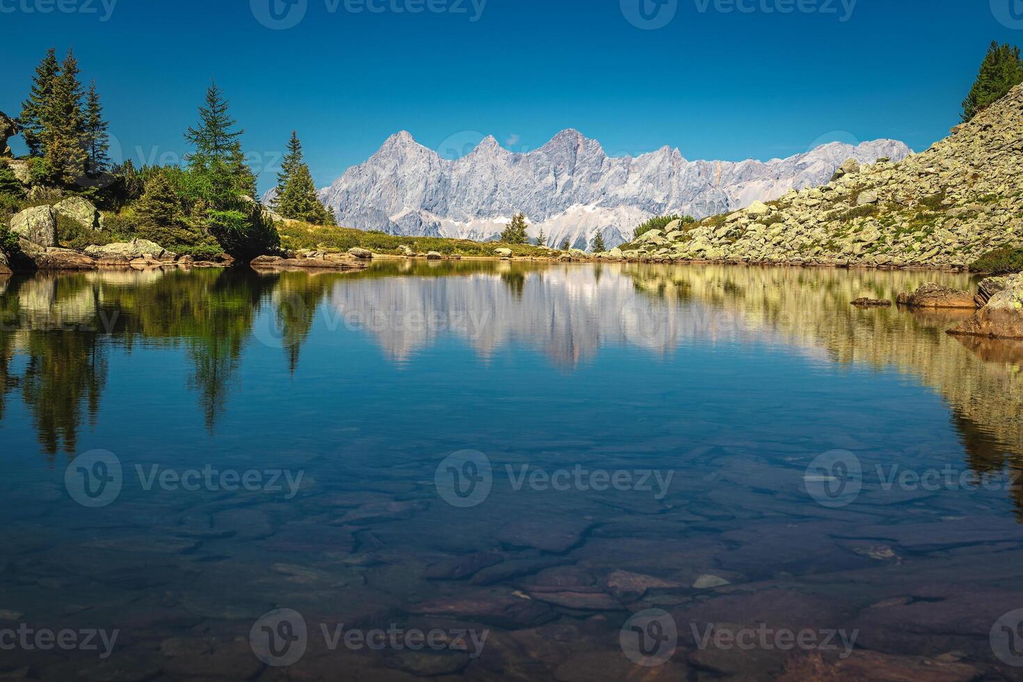 Stunning mountain lake and high mountain ridges in Austria photo
