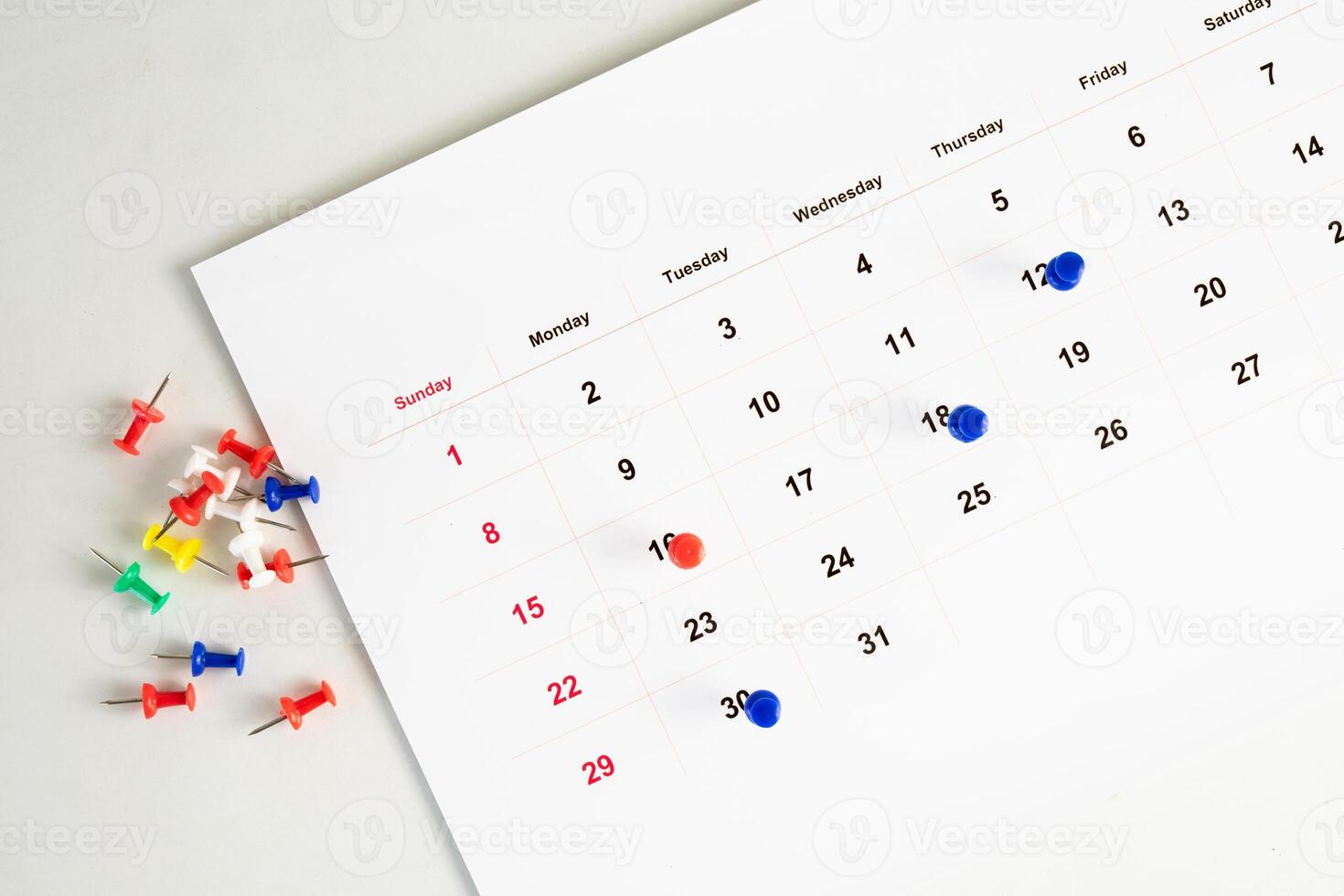 push pin stuck in calendar background photo