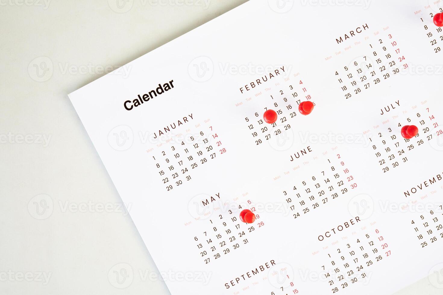 calendar with red reminder pin sign photo