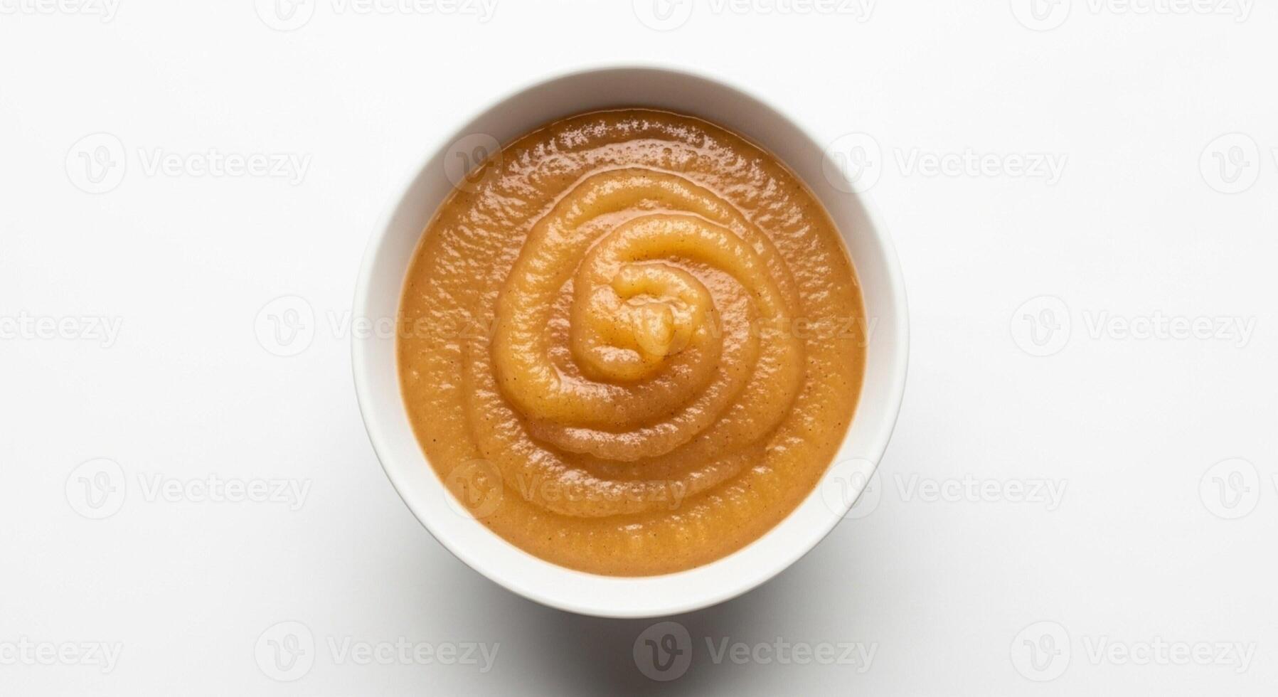 A small bowl of apple sauce isolated on white photo