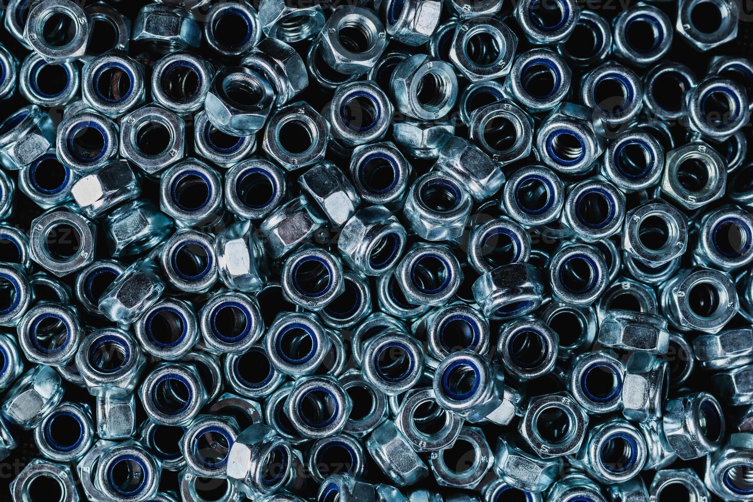 Fastening material. Metal nuts with anti-unscrewing check ring. Background image photo