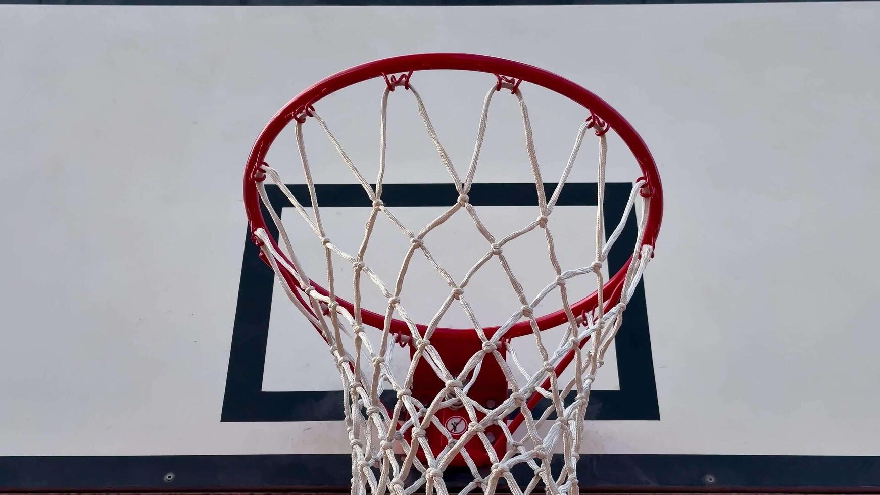 A Dynamic Basketball Hoop Perspective capturing the thrilling action and energy of the game photo