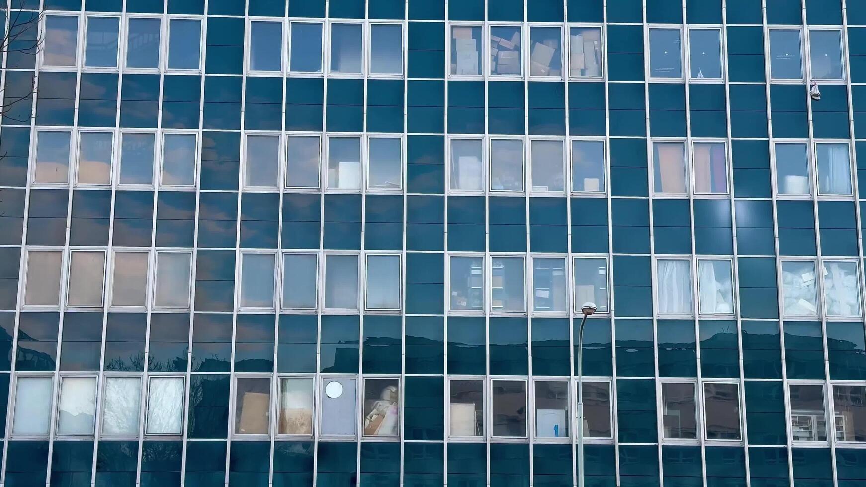 An exceptionally designed modern glass building facade showcases stunning window reflections photo