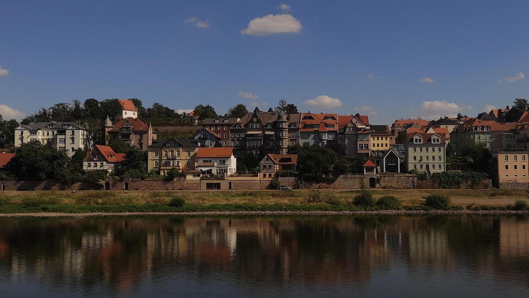 Dresden, Germany - September 7, 2024 Picturesque german town reflecting on the elbe river under a blue sky photo