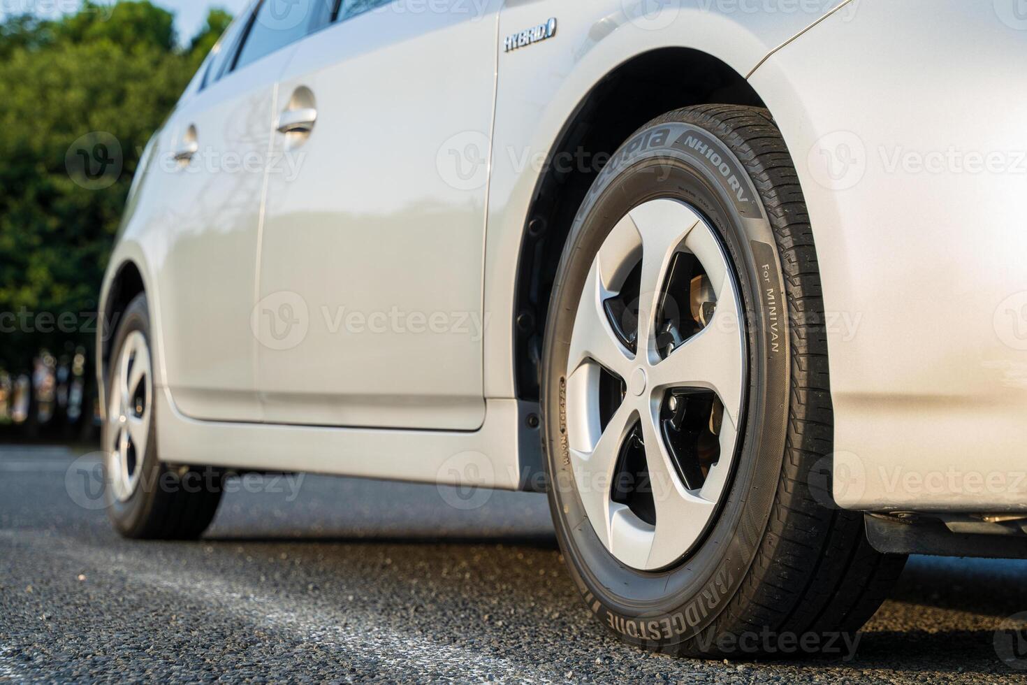 Side of a silver car with tires photo