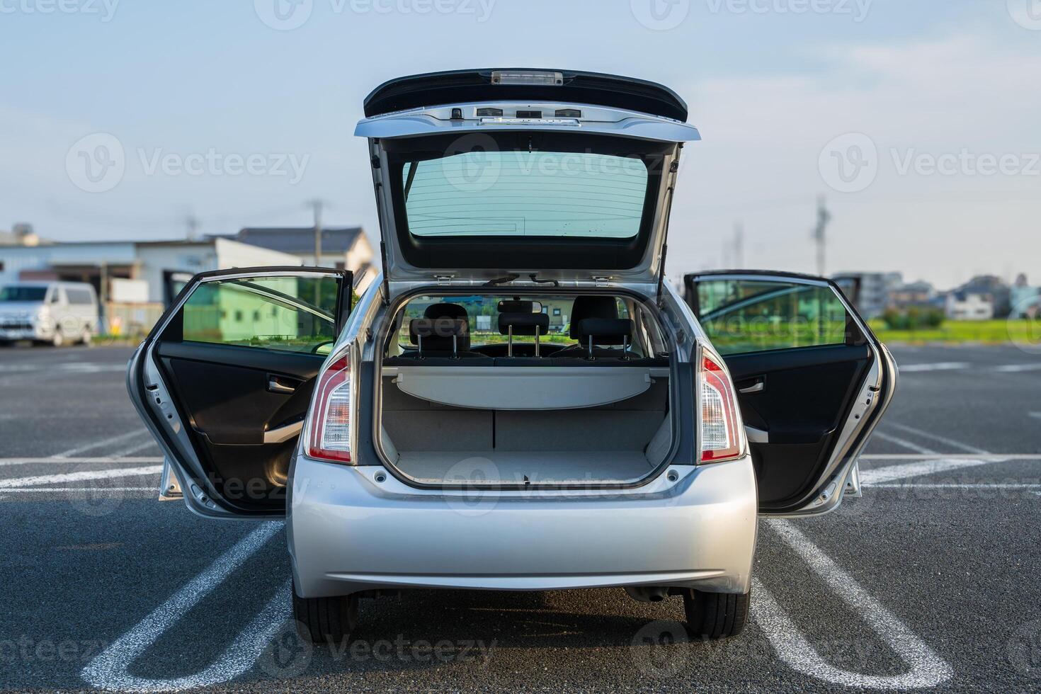 Back of a silver car with doors open photo