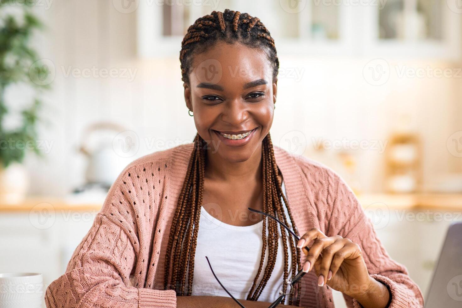 Successful Freelancer. Portraif Of Happy Black Lady Sitting At Desk With Computer At Home, Confident Positive African American Woman Holding Glasses In Hands And Looking At Camera, Enjoying Remote Job photo