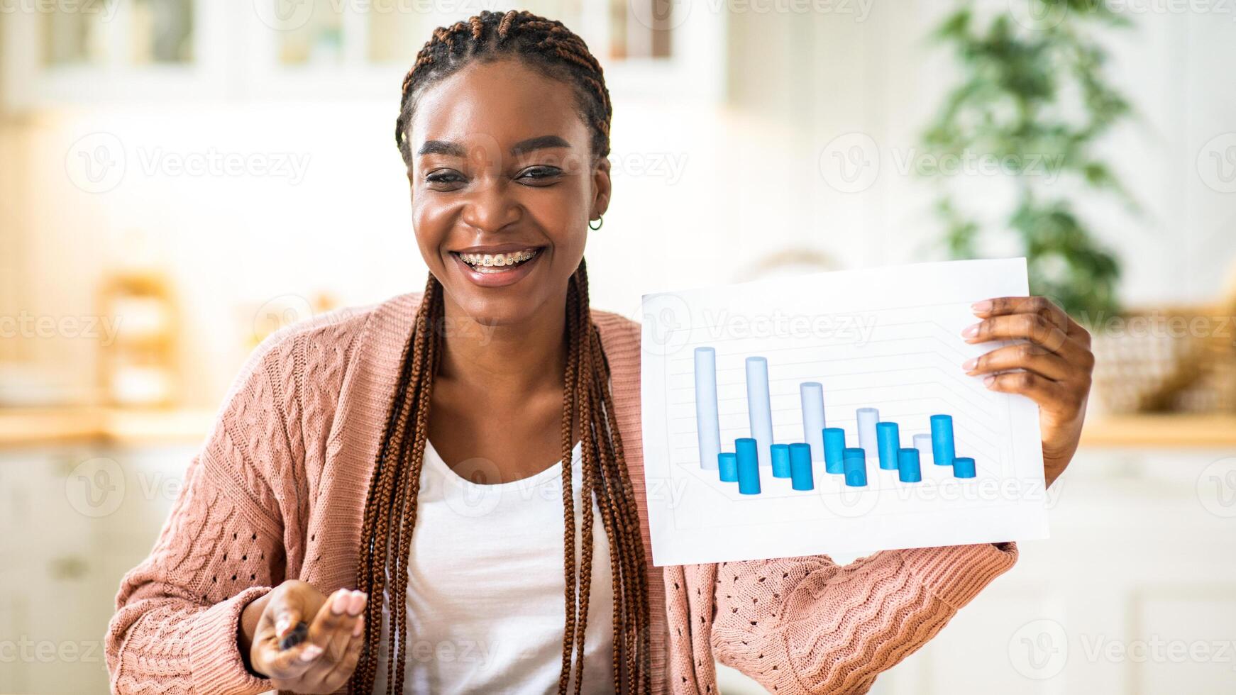 Work From Home. Cheerful African Financial Councelor Woman Showing Financial Reports At Camera, Smiling Black Lady Demonstrating Economical Graphs And Charts, Making Virtual Presentation, Free Space photo