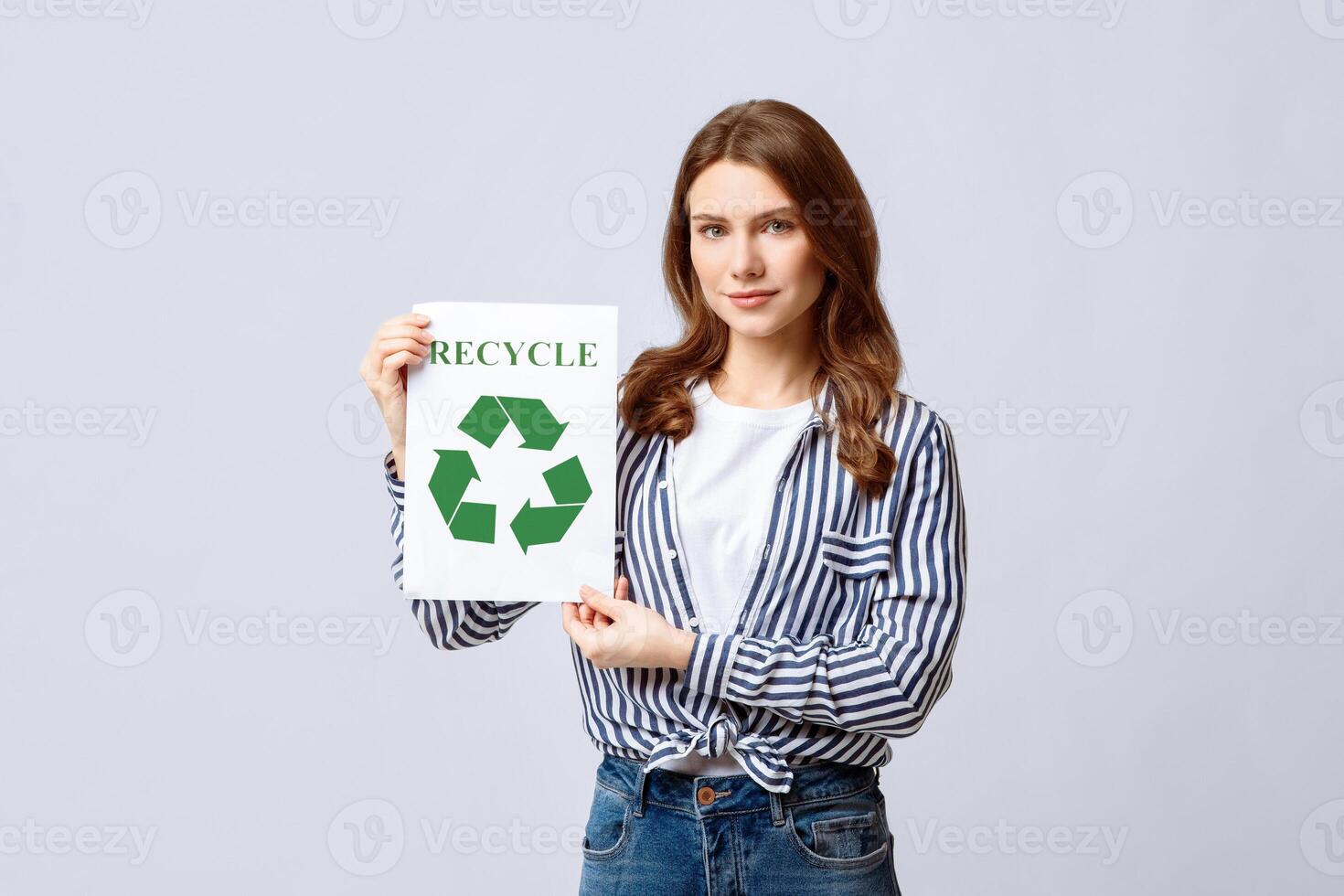 Recycling Concept. Eco-Activist Holding Placard With Green Recycle Sign Icon, Positive Millennial Nature-Friendly Woman Posing On Light Studio Background With Copy Space photo
