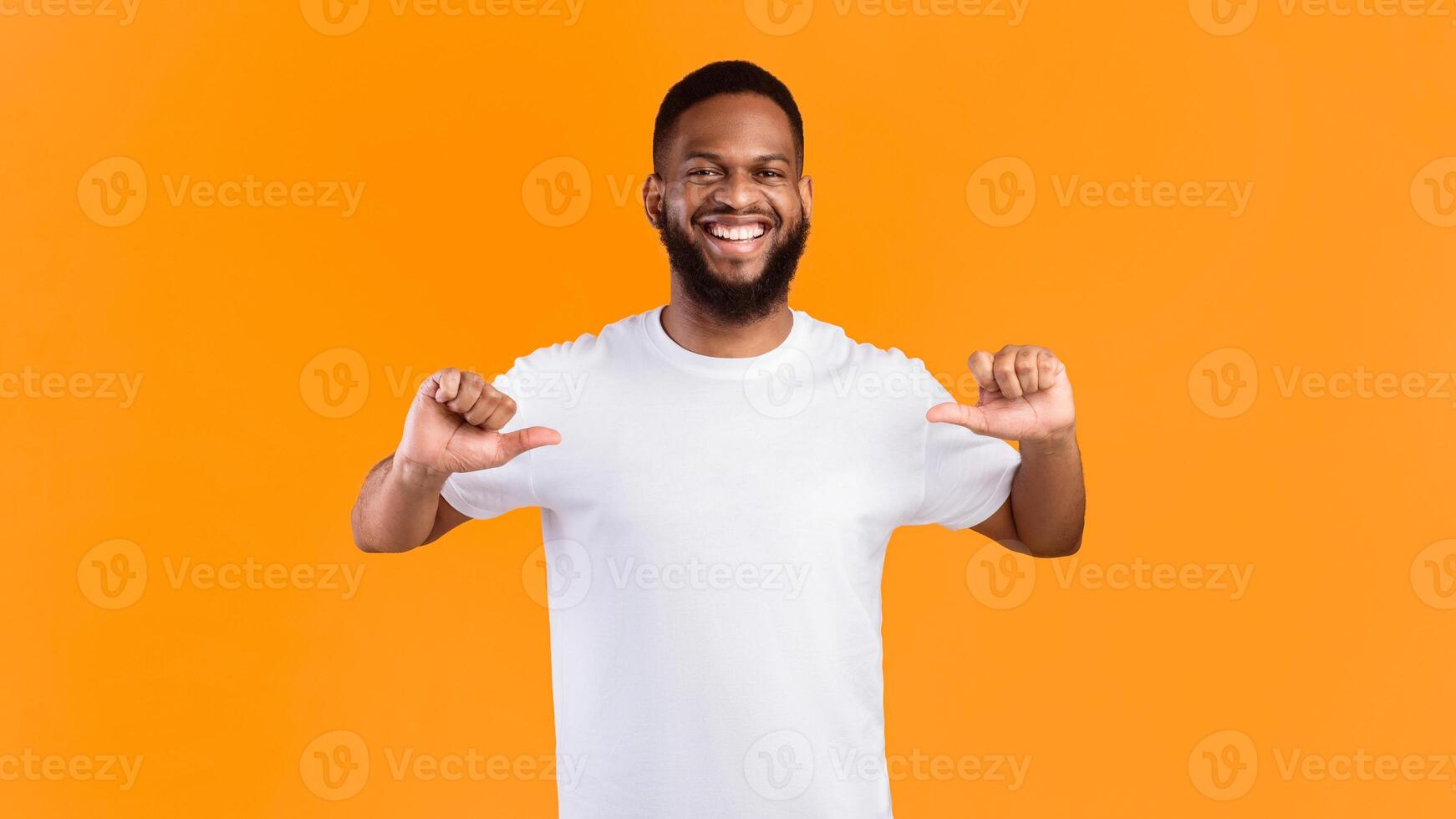Choose Me. Happy African Man Pointing Fingers Thumbs At Himself Standing Over Yellow Studio Background, Smiling To Camera. Self-Confidence, Look At Me Concept. Panorama photo