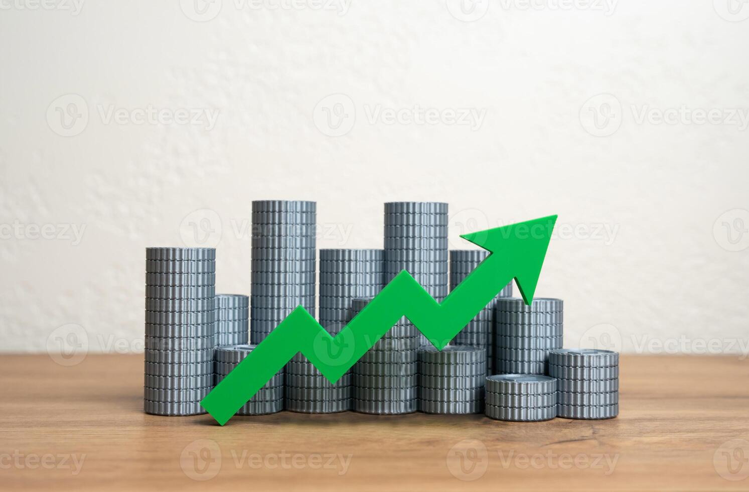Stacks of money coins and a green arrow pointing up. Increasing income and wealth. Growth of the money supply. Increasing the economy. Wealth growth, capital accumulation, or a booming economy. photo