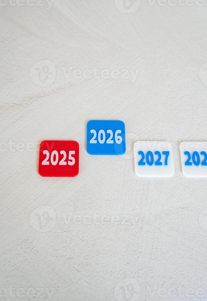 New 2026 and the outgoing 2025. New plans and forecasts. To sum up and outline new guidelines. Economic outlooks, business strategies, calendar transitions, or financial and personal goal setting. photo