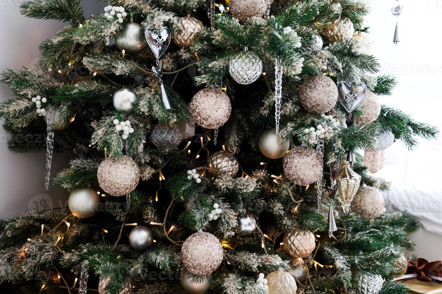 Beautifully decorated Christmas tree with ornaments in a cozy living room setting photo