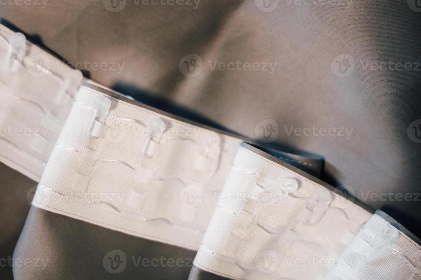 White fabric with woven design and stitching displayed in soft lighting photo