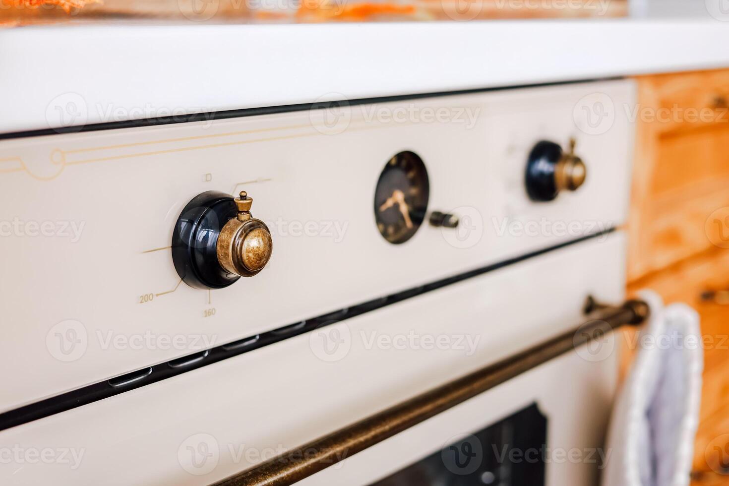 Vintage stove with intricate knobs in a cozy kitchen setting during daylight hours photo