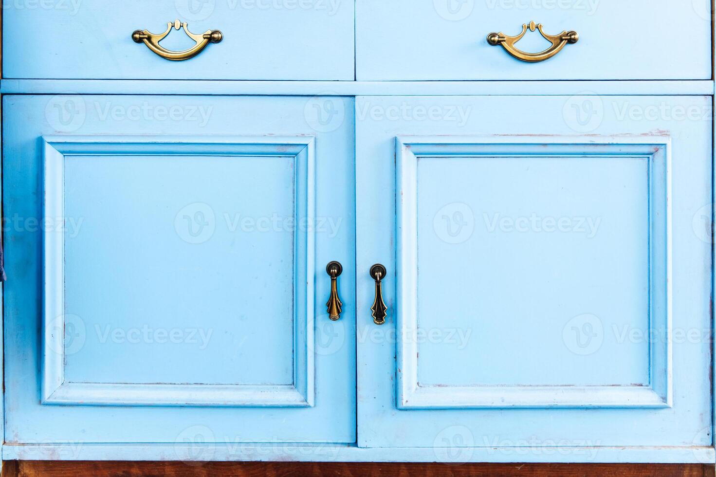 Classic blue cabinet with elegant golden handles in modern interior setup photo