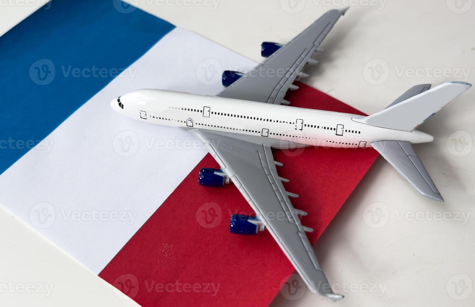 Flag of France and toy airplane . Flight travel concept photo