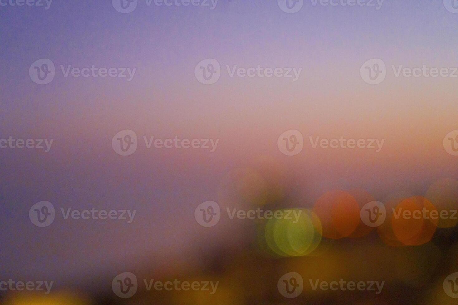 Abstract blurred background featuring soft bokeh lights in various colors, creating a dreamy atmosphere with a gradient of warm and cool tones, ideal for artistic and creative projects photo