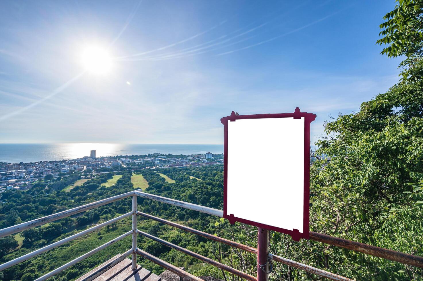 Blank billboard on the top of a hill with a view of the city photo