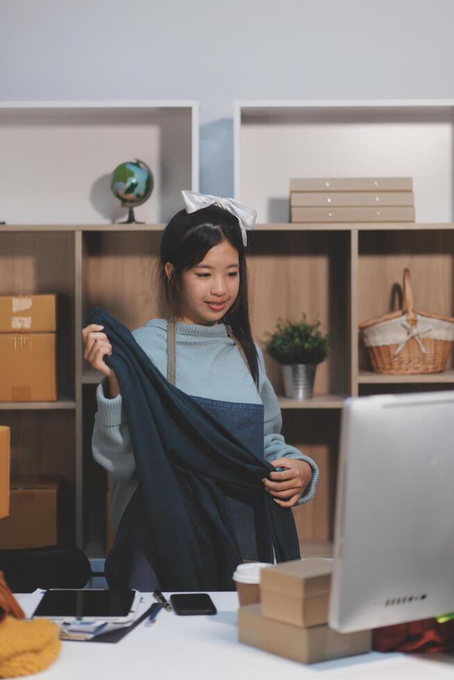 A woman is standing in front of a desk with boxes photo