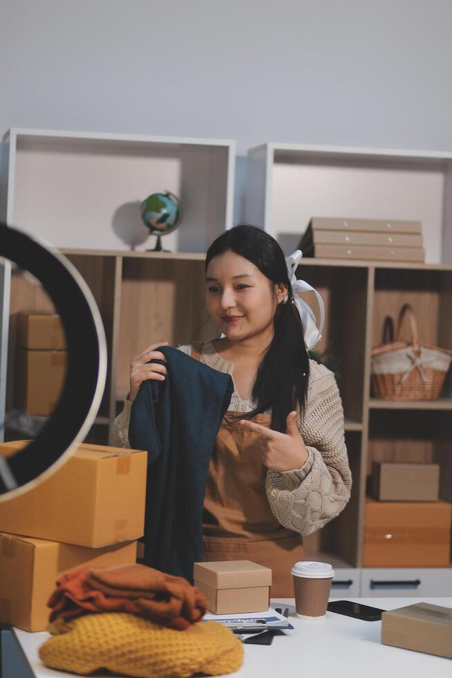 A woman sitting at a desk with a laptop and a box photo