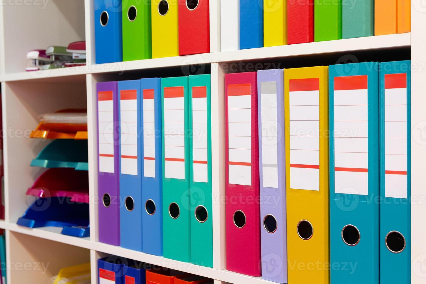 Colorful folders on a shelf in a modern office space photo