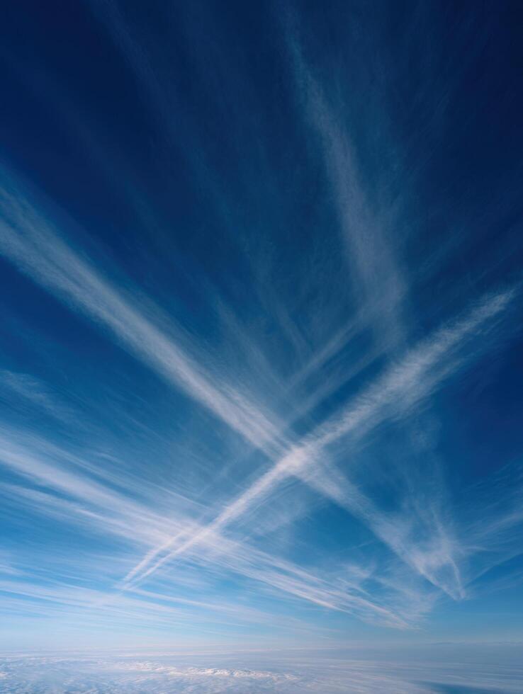 Long White Contrails Seen Against A Clear Blue Backdrop photo