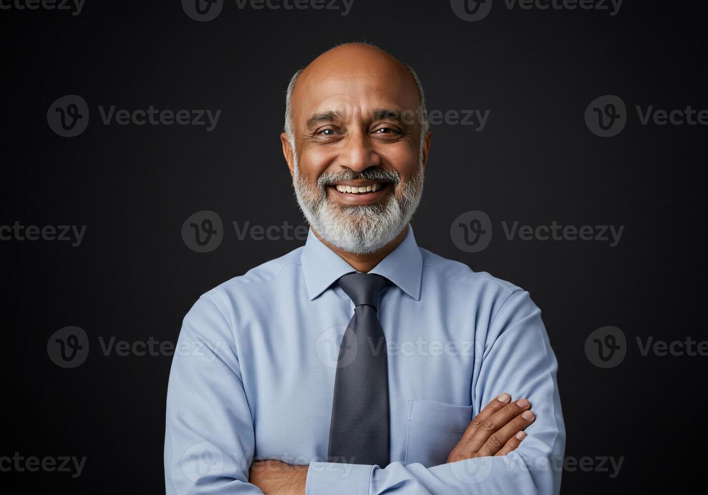 Portrait of a smiling indian businessman on black background photo