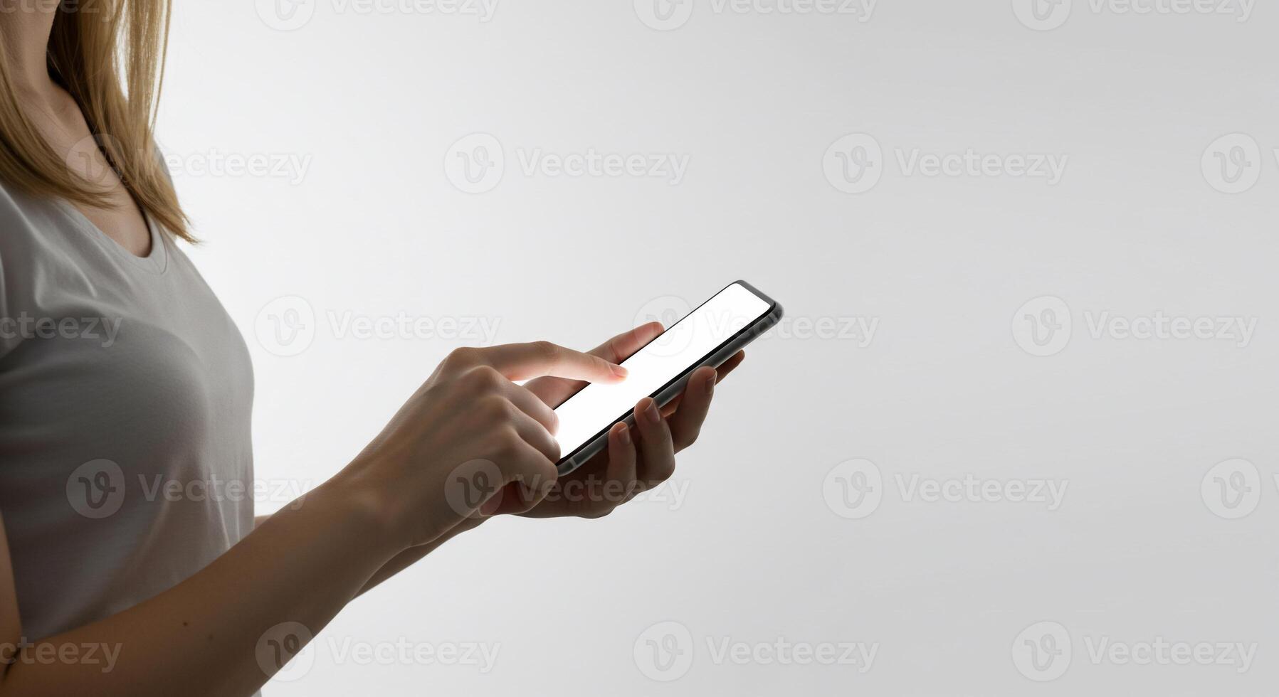 A woman holding a smart phone in her hand photo