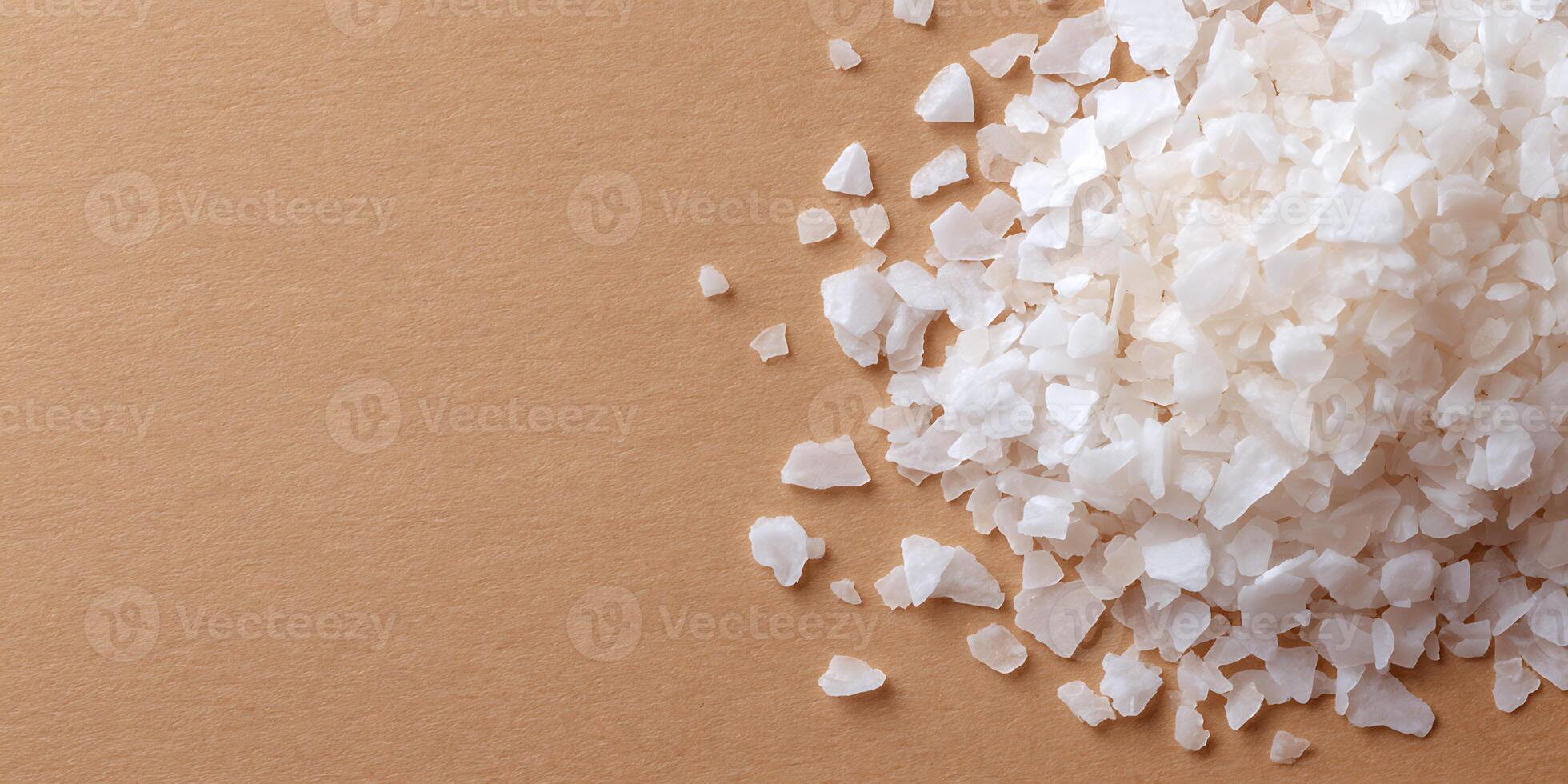 White Sea Salt on brown background. photo