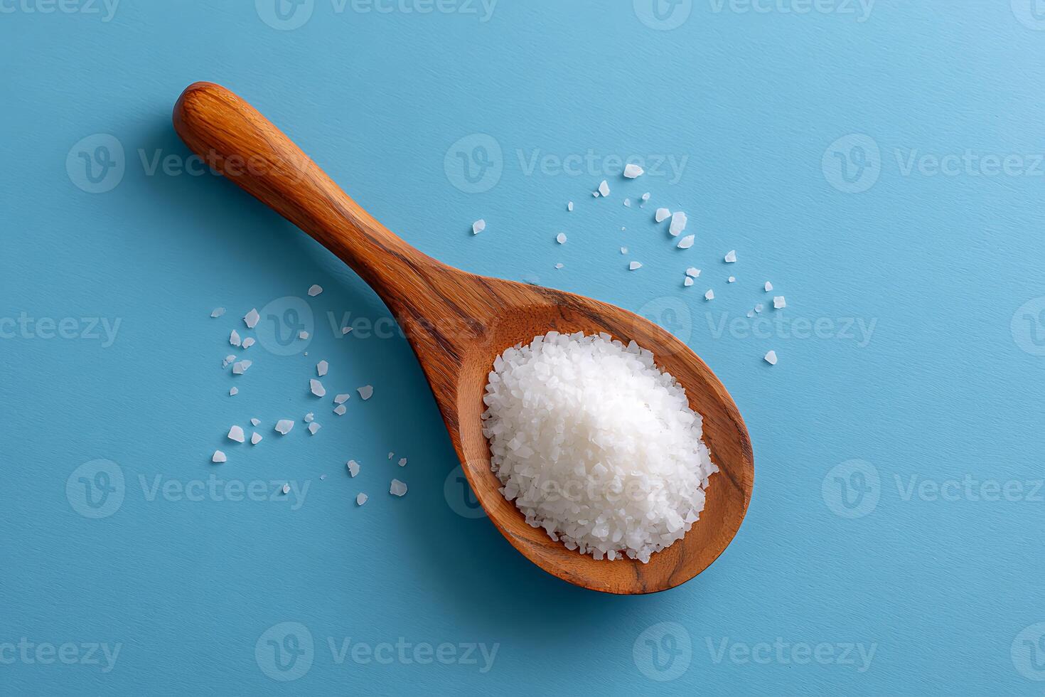 White sea salt in wooden spoon photo