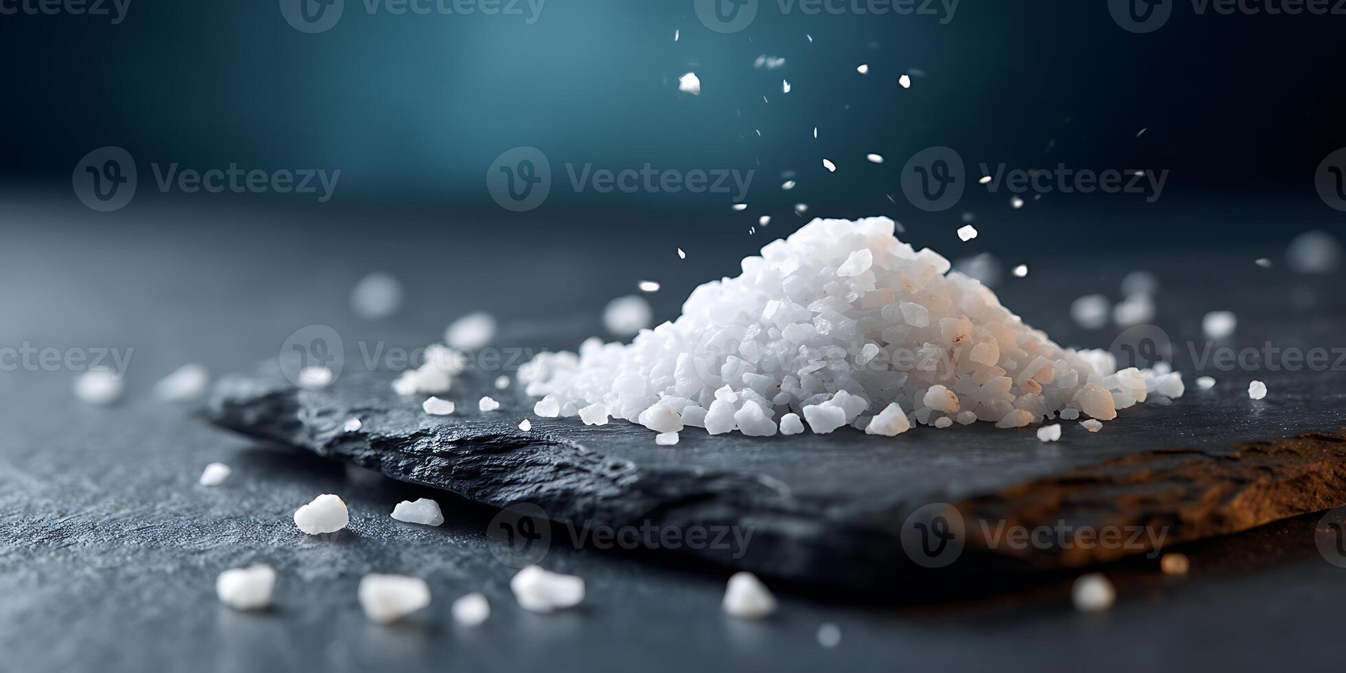 Flat Lay of Salt on black stone plate photo