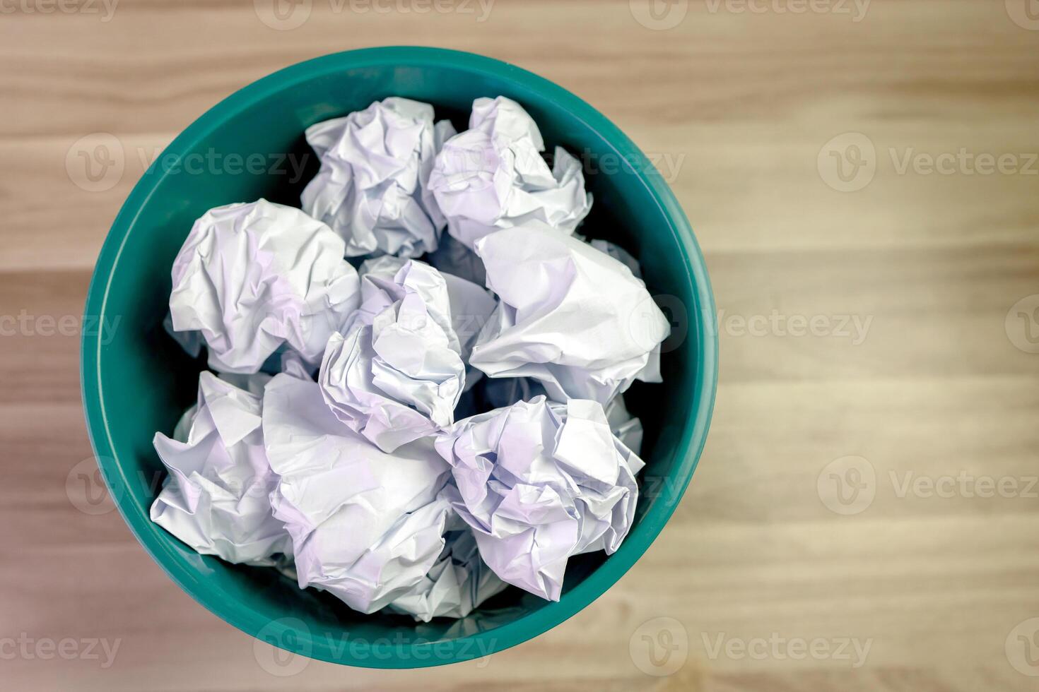 crumpled paper ball in trash can, paper waste. trash bin in office with crumple paper ball, work hard ideas concept photo