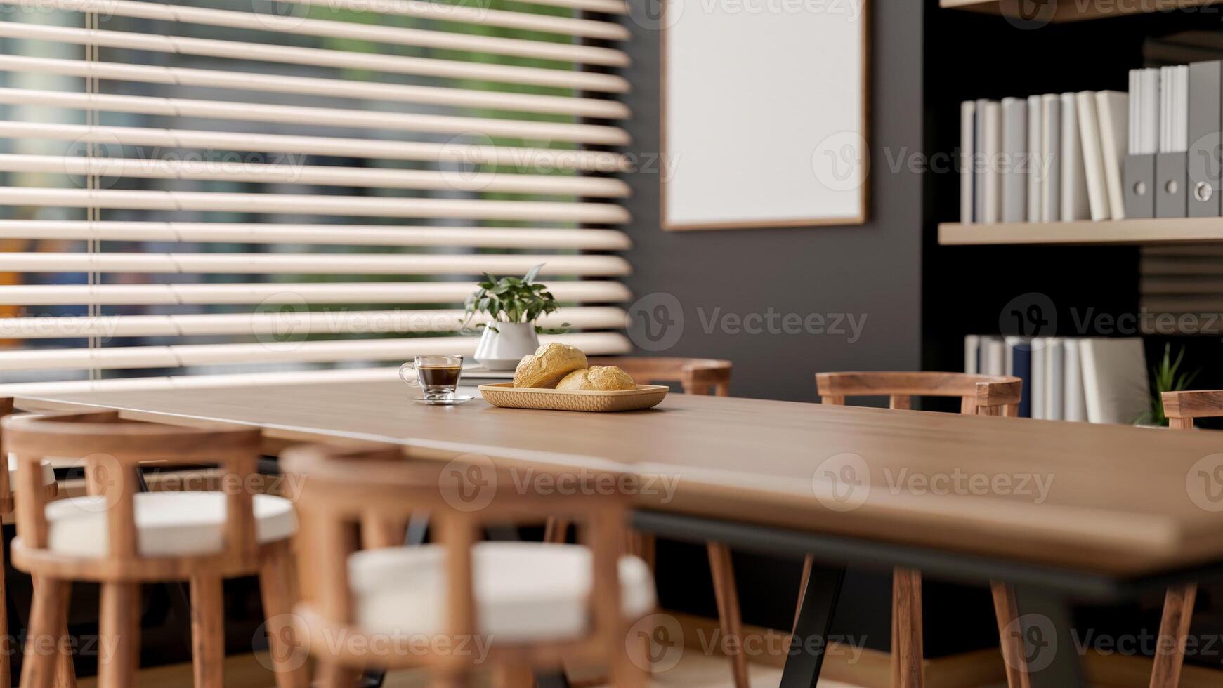 The bread on plate and coffee cup on wooden table with armchairs next to window in office break room photo