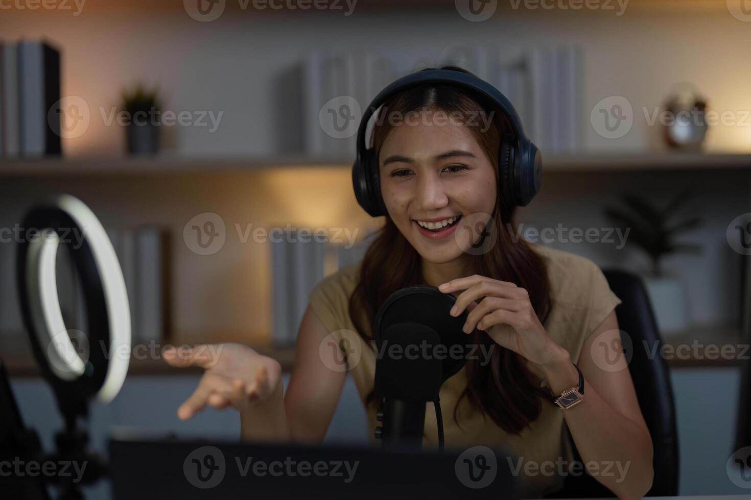 Remote Work and Digital Communication. Young woman actively participating in a call with a microphone. photo