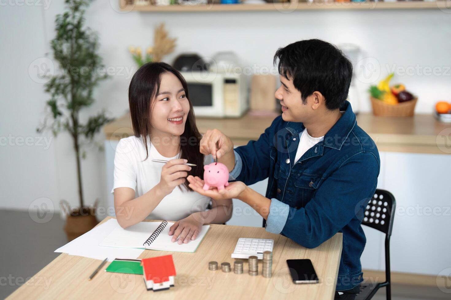 Couple Engaging in Savings Discussion. Young adults planning finances with a piggy bank. photo