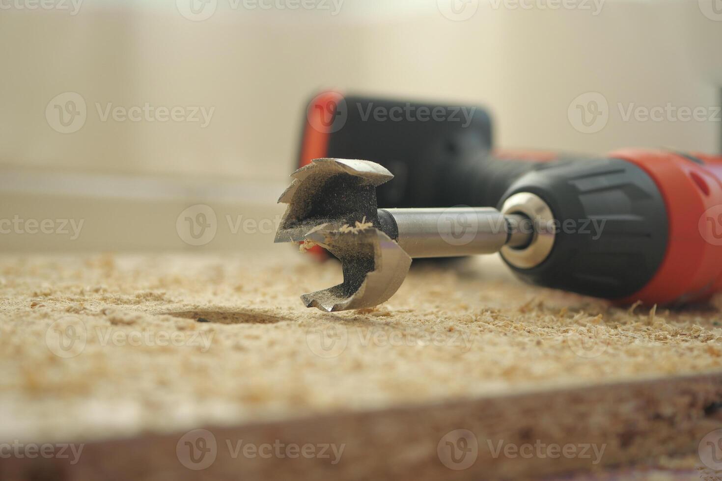 Close-up of a drill bit on a wooden surface during a project photo