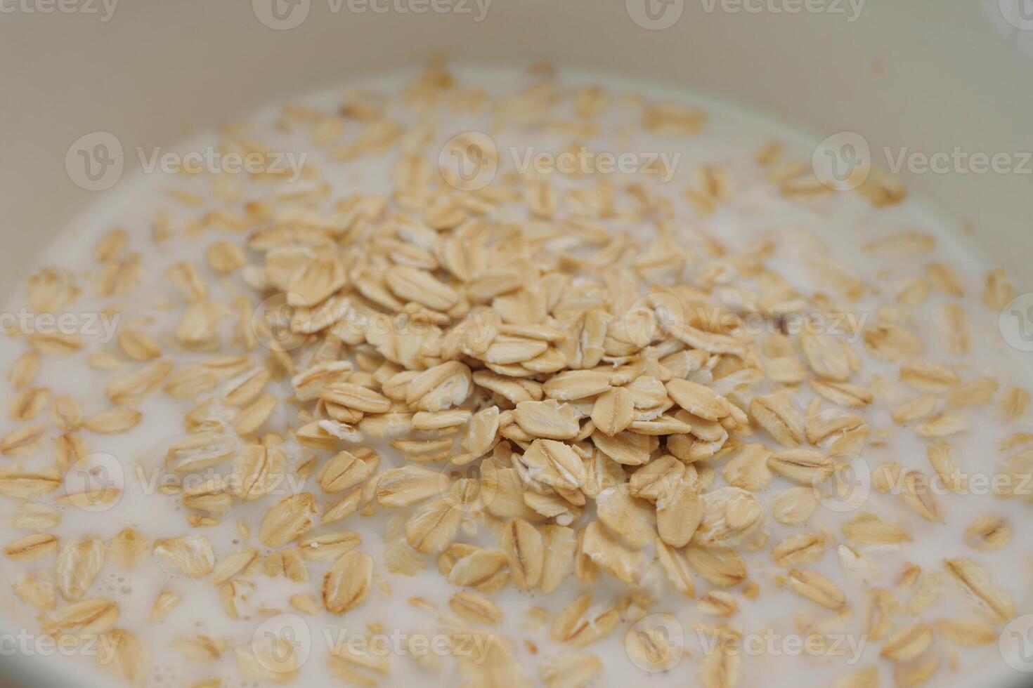 Oats soaking in milk for a healthy breakfast preparation photo