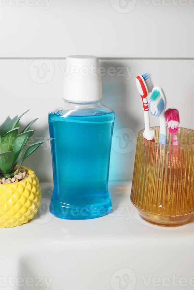 Bright bathroom setup with mouthwash and toothbrush holders photo
