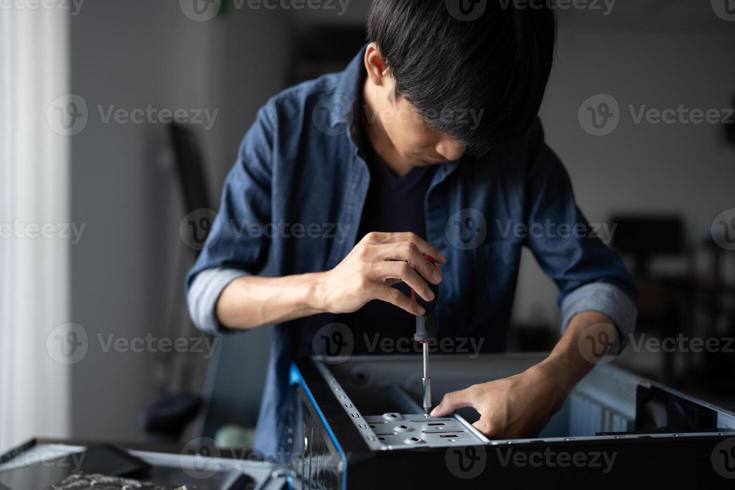 a Engineer installing Hardware man is working on a computer in a room photo