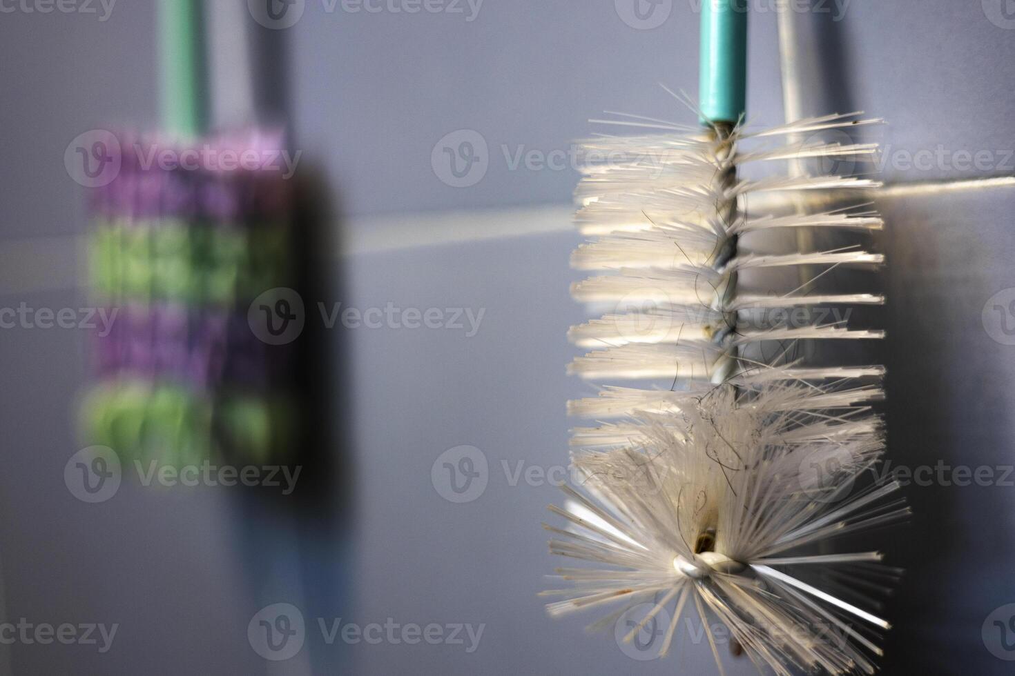 Bottle Brush Is Hung On The Wall In The Bathroom photo