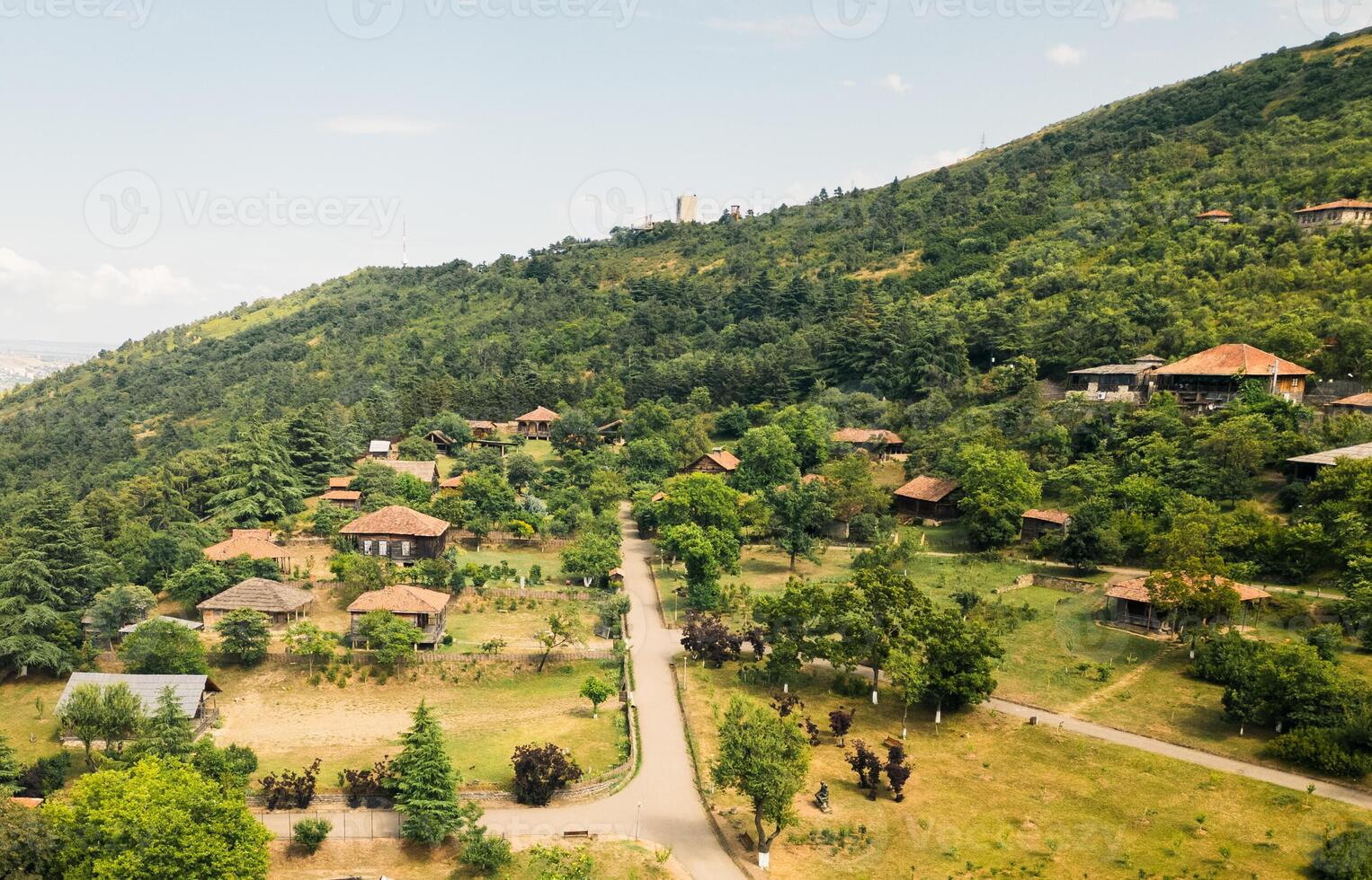 Aerial traditional Georgian architecture wooden houses towers displayed in Giorgi Chitaia Open Air Museum of Ethnography in Tbilisi. Cultural heritage site on Tbilisi hills Vake district. photo
