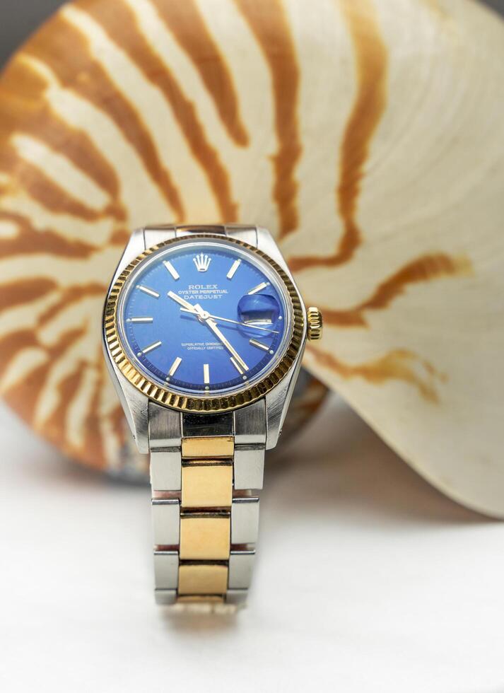 Cremona, Italy, 2021 - Rolex Oyster Blue watch on seashell background. Rolex SA is an important Swiss luxury company in the production of wrist watches, founded in London, in 1905 photo