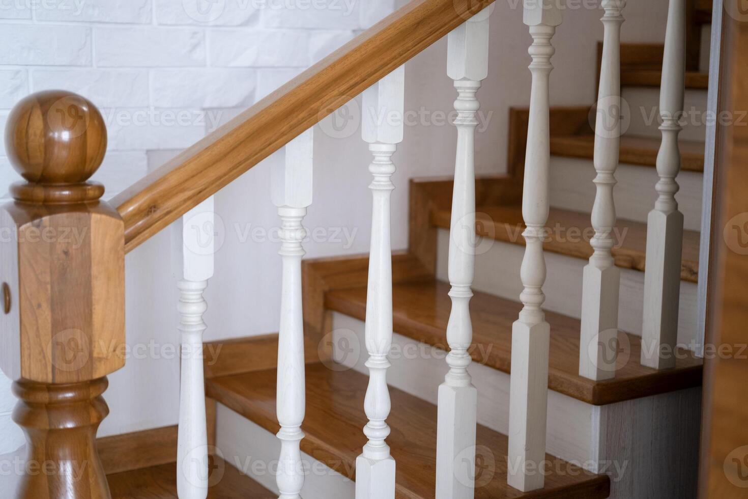 A wooden, staircase with, a railing will lead to the top photo