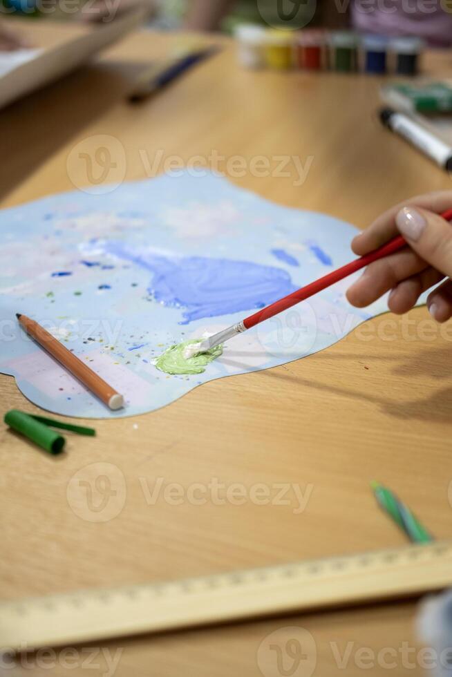 Children, draw on the poster with pencils and paints photo