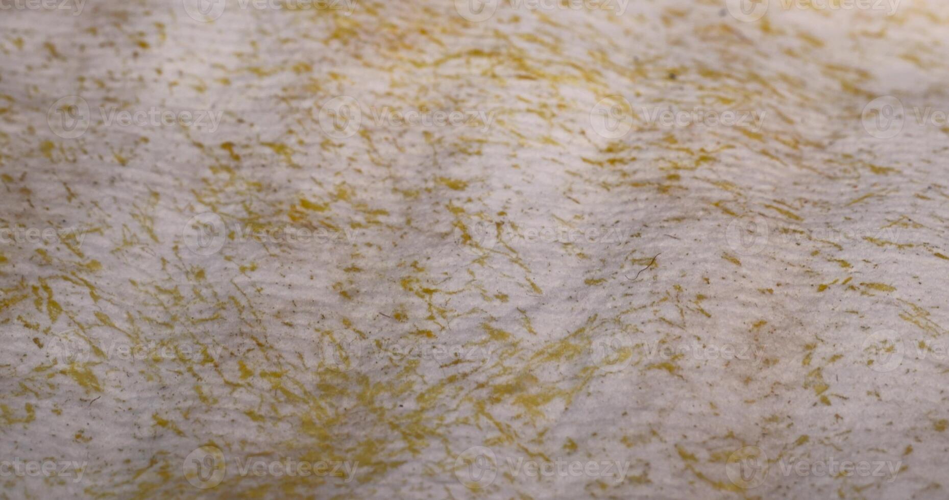 old fabric from an old used mattress in yellow glue photo