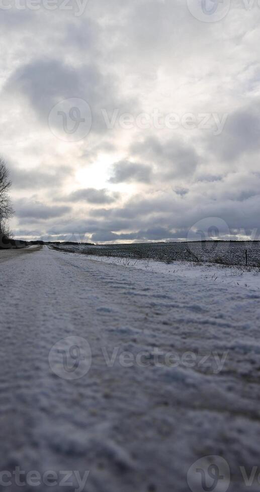 a dirty slippery road in winter after a snowfall photo
