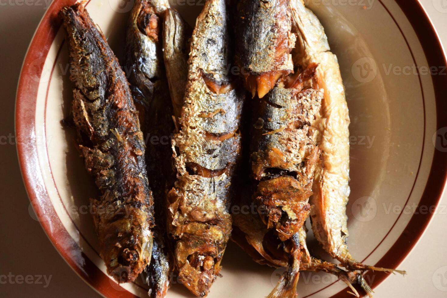 Closeup photo of crispy fried Indonesian fish on plate